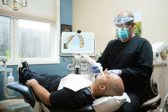 Dentist and patient in exam room