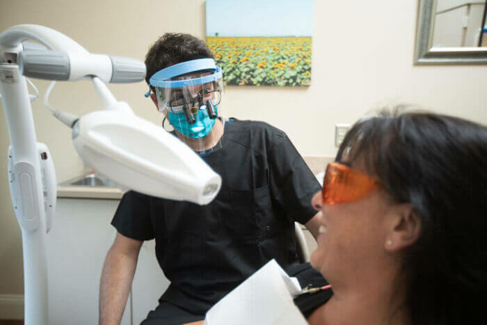 Dentist and patient in exam room